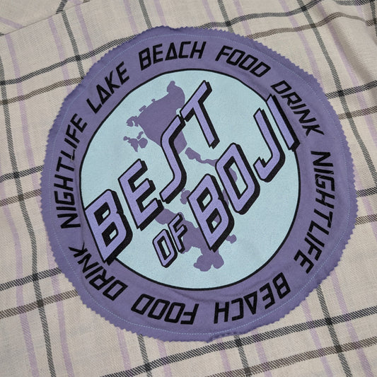 Round patch with 'Best of Boji' text on a checkered fabric background
