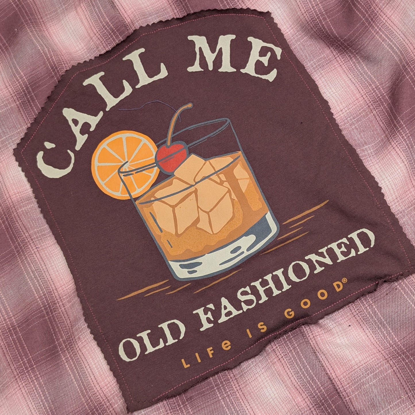 T-shirt with 'Call Me Old Fashioned Life is Good' design on a plaid shirt background