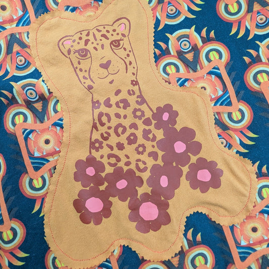 Short Sleeve button up shirt with bright orange graphic patterns. Featuring an orange and red cheetah graphic on a grey background. 
