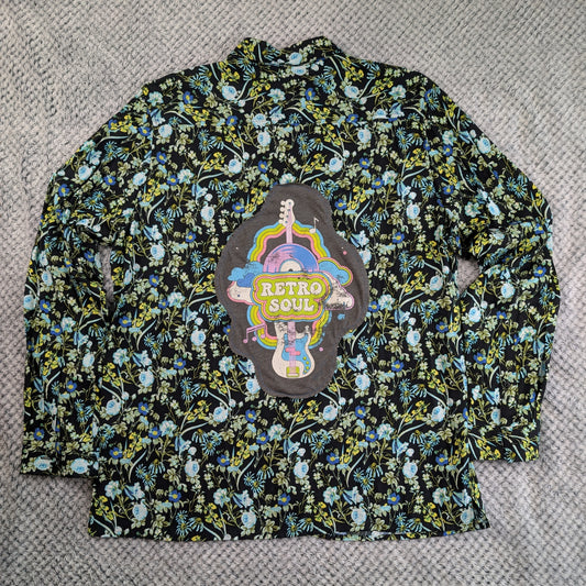 A long-sleeve button-up shirt with a black background and a dense multicolor floral print, featuring a large 'Retro Soul' patch on the chest.